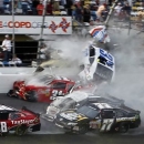Kyle Larson (32) goes into the catch fence as he collides with Justin Allgaier (31), Brian Scott (2), Parker Klingerman (77) and Dale Earnhardt Jr. (88) at the conclusion of the NASCAR Nationwide Series auto race Saturday, Feb. 23, 2013, at Daytona International Speedway in Daytona Beach, Fla. (AP Photo/Terry Renna)