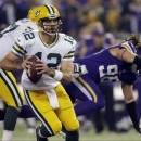 Green Bay Packers quarterback Aaron Rodgers (12) runs in the first half of an NFL football game against the Minnesota Vikings, Sunday, Oct. 27, 2013, in Minneapolis. (AP Photo/Jim Mone)