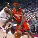 Syracuse's C.J. Fair (5) drives around Arkansas' Michael Qualls during the first half of an NCAA college basketball game in Fayetteville, Ark., Friday, Nov. 30, 2012. (AP Photo/Gareth Patterson)