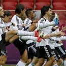 German team mates stretch during a training session ahead of Thursday's Euro 2012 soccer semifinal match between Germany and Italy in Warsaw, Poland, Wednesday, June 27, 2012. (AP Photo/Frank Augstein)