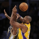 Utah Jazz forward Derrick Favors, left, and Los Angeles Lakers guard Kobe Bryant, right, fight for a loose ball in the first half of an NBA preseason basketball game, Saturday, Oct. 13, 2012, in Los Angeles. (AP Photo/Gus Ruelas)