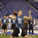 Syracuse quarterback Ryan Nassib runs a drill at the NFL football scouting combine in Indianapolis, Sunday, Feb. 24, 2013. (AP Photo/Michael Conroy)
