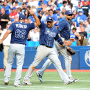 Tampa Bay Rays' Yunel Escobar, center, celebrates with teammates Joel Peralta and James Loney after turning a bases-loaded double play to end the seventh inning against the Toronto Blue Jays in a baseball game Sunday, Sept. 29, 2013, in Toronto. (AP Photo/The Canadian Press, Jon Blacker)