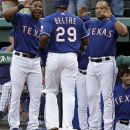 Texas Rangers' Elvis Andrus, left, and Yorvit Torrealba, right, congratulate teammate Adrian Beltre (29) on his solo home run off of New York Yankees' Phil Hughes in the second inning of a baseball game on Wednesday, April 25, 2012, in Arlington, Texas. (AP Photo/Tony Gutierrez)