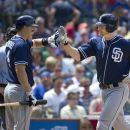 San Diego Padres' Nick Hundley, left, high-fives teammate Chase Headley after Headley hit a solo home run during the fourth inning of a baseball game against the Chicago Cubs, Monday, May 28, 2012 in Chicago.  (AP Photo/Brian Kersey)