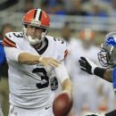 Cleveland Browns quarterback Brandon Weeden (3) is stripped of the ball by Detroit Lions defensive end Willie Young (79) during the first quarter of an NFL preseason football game in Detroit, Friday, Aug. 10, 2012. (AP Photo/Carlos Osorio)