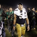 FILE - In this Nov. 17, 2012, file photo, Notre Dame linebacker Manti Te'o walks off the field following an NCAA college football game against Wake Forest in South Bend, Ind. A story that Te'o's girlfriend had died of leukemia _ a loss he said inspired him to help lead the Irish to the BCS championship game _ was dismissed by the university Wednesday, Jan. 16, 2013, as a hoax perpetrated against the linebacker. (AP Photo/Michael Conroy, File)