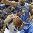 Minnesota Timberwolves' J.J. Barea, left, drives past Denver Nuggets' JaVale McGee during the first half of an NBA basketball game Thursday, April 26, 2012, in Minneapolis. (AP Photo/Jim Mone)