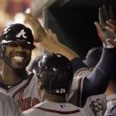 Atlanta Braves' Jason Heyward smiles in the dugout after hitting a two-run home run during the 12th inning of a baseball game against the St. Louis Cardinals Friday, May 11, 2012, in St. Louis. The Braves won 9-7. (AP Photo/Jeff Roberson)