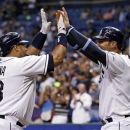 Tampa Bay Rays' Jose Molina, left, is congratulated by teammate Carlos Pena after his two-run home run during the second inning of a baseball game against the Toronto Blue Jays on Friday, Sept. 21, 2012, in St. Petersburg, Fla. (AP Photo/Mike Carlson)