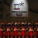 Traditional drum dancers perform as the emblem of the PyeongChang 2018 Olympic Winter Games is seen (top) during its Launch Ceremony in Seoul May 3, 2013. REUTERS/Kim Hong-Ji
