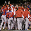 Puerto Rico's Alex Rios (51) celebrates with teammates after hitting a two-run home run against Japan during the seventh inning of a semifinal game of the World Baseball Classic in San Francisco, Sunday, March 17, 2013. (AP Photo/Ben Margot)