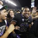 Fans surround Washington's Bishop Sankey after fans ran onto the field to celebrate Washington's 17-13 upset of Stanford in an NCAA college football game, Thursday, Sept. 27, 2012, in Seattle. (AP Photo/Ted S. Warren)