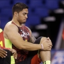 Notre Dame linebacker Manti Te'o stretches during the NFL football scouting combine in Indianapolis, Monday, Feb. 25, 2013. (AP Photo/Dave Martin)