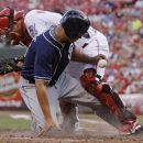 San Diego Padres' Will Venable, front, is safe at home as he knocks the ball loose from Cincinnati Reds catcher Devin Mesoraco in the second inning of a baseball game, Monday, July 30, 2012, in Cincinnati. (AP Photo/Al Behrman)
