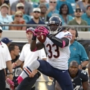 Chicago Bears cornerback Charles Tillman (33) intercepts a Jacksonville Jaguars pass before running it back for a 36-yard touchdown during the second half of an NFL football game, Sunday, Oct. 7, 2012, in Jacksonville, Fla. (AP Photo/Phelan M. Ebenhack)