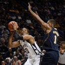 Penn State's Brandon Taylor (10) looks for a shot past Michigan's Glenn Robinson III (1) during the first half of an NCAA college basketball game in State College, Pa., Wednesday, Feb. 27, 2013. (AP Photo/Ralph Wilson)