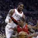 Los Angeles Clippers guard Eric Bledsoe, right, drives past Portland Trail Blazers forward LaMarcus Aldridge during the first quarter of an NBA basketball game in Portland, Ore., Saturday, Jan. 26, 2013. (AP Photo/Don Ryan)