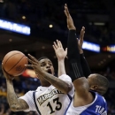 Marquette's Vander Blue (13) shoots over Seton Hall's Eugene Teague (21) during the first half of an NCAA college basketball game Wednesday, Jan. 16, 2013, in Milwaukee. (AP Photo/Morry Gash)