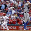 Los Angeles Dodgers starting pitcher Chris Capuano stands on the mound after Philadelphia Phillies' Shane Victorino hit a solo home run in the second inning of a baseball game, Wednesday, June 6, 2012, in Philadelphia. (AP Photo/H. Rumph Jr)