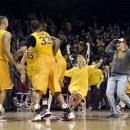 Fans rush the court after Minnesota defeated Indiana 77-73 in an NCAA college basketball game, Tuesday, Feb. 26, 2013, in Minneapolis. (AP Photo/Tom Olmscheid)