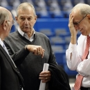 Former Connecticut head coach Jim Calhoun, center, speaks with Associated Press writer Jim O'Connell, left, as Syracuse head coach Jim Boeheim, right, reacts, before an NCAA college basketball game between the two teams in Hartford, Conn., Wednesday, Feb. 13, 2013. (AP Photo/Jessica Hill)