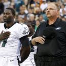 Philadelphia Eagles coach Andy Reid, right, stands on the field with quarterback Michael Vick (7) before an NFL preseason football game against the Pittsburgh Steelers on Thursday, Aug. 9, 2012, in Philadelphia. (AP Photo/Mel Evans)