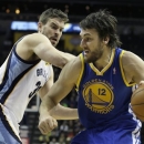 Golden State Warriors' Andrew Bogut (12), of Australia, moves the ball in front of Memphis Grizzlies' Marc Gasol (33), of Spain, during the first half of an NBA basketball game in Memphis, Tenn., Friday, Feb. 8, 2013. (AP Photo/Danny Johnston)
