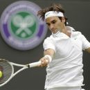Roger Federer of Switzerland returns a shot to Albert Ramos of Spain during a first round men's singles match at the All England Lawn Tennis Championships at Wimbledon, England, Monday, June 25, 2012. (AP Photo/Tim Hales)