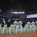 Chicago White Sox observe the national anthem ahead of a baseball game against the Toronto Blue Jays in Toronto on Monday, April 15, 2013. (AP Photo/The Canadian Press, Chris Young)