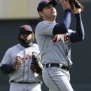 Detroit Tigers pitcher Anibal Sanchez fields an infield popup for the out off the bat of Minnesota Twins' Pedro Florimon in the third inning of a baseball game Sunday, Sept. 30, 2012 in Minneapolis. Watching, left, is Tigers first baseman Prince Fielder. (AP Photo/Jim Mone)