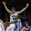 Rhode Island guard Xavier Munford (5) crashes into Butler center Andrew Smith in the first half of an NCAA college basketball game in Indianapolis, Saturday, Feb. 2, 2013. (AP Photo/Michael Conroy)