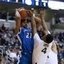 Saint Louis forward Dwayne Evans (21) is pressured by Xavier forward Travis Taylor (4) during the first half of an NCAA college basketball game, Wednesday, March 6, 2013, in Cincinnati. (AP Photo/David Kohl)