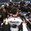 Texas A&M quarterback Johnny Manziel (2) talks to reporters during media day for the Cotton Bowl Classic NCAA college football game at Cowboys Stadium, Sunday, Dec. 30, 2012, in Arlington, Texas. Oklahoma and Texas A&M are scheduled to play on Jan. 4, 2013. (AP Photo/LM Otero)