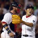 Boston Red Sox closer Koji Uehara, right, celebrates with catcher Jarrod Saltalamacchia after they defeated the Baltimore Orioles 4-3 in a baseball game at Fenway Park in Boston, Wednesday, Aug. 28, 2013. (AP Photo/Elise Amendola)