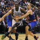 Boston Celtics' Jeff Green, left, is squeezed by New York Knicks' Mychel Thompson (20) during the second half of an NBA preseason game in Albany, N.Y. on Saturday, Oct. 20, 2012. (AP Photo/Tim Roske)