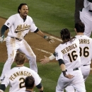 Oakland Athletics left fielder Coco Crisp (4) celebrates after he hit single to score Seth Smith and win the game 4-3 in the ninth inning of Game 4 of an American League division baseball series against the Detroit Tigers in Oakland, Calif., Wednesday, Oct. 10, 2012. (AP Photo/Eric Risberg)