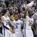 Villanova's Maurice Sutton (25), Tony Chennault (5) and JayVaughn Pinkston (22) celebrate from the bench during the second half of an NCAA college basketball game against Georgetown, Wednesday, March 6, 2013, in Philadelphia. Villanova won 67-57. (AP Photo/Michael Perez)