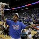 Kansas guard Travis Releford cuts down the net after winning the Big 12 men's NCAA college basketball championship game against Kansas State, Saturday, March 16, 2013, in Kansas City, Mo. Kansas won the game 70-54. (AP Photo/Charlie Riedel)