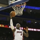 LeBron James of the Miami Heat goes up for a hoop during an NBA preseason basketball game against the Los Angeles Clippers in Shanghai, China, Sunday Oct. 14, 2012. (AP Photo/Kin Cheung)
