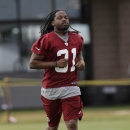 Washington Redskins free safety Brandon Meriweather (31) runs to the field during the NFL football teams training camp practice in Richmond, Va. Monday, July 29, 2013. (AP Photo/Steve Helber)