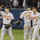 Baltimore Orioles' Nate McLouth (9) and J.J. Hardy (2) celebrate with teammates after Game 4 of the American League division baseball series against the New York Yankees late Thursday, Oct. 11, 2012, in New York. The Orioles won 2-1. (AP Photo/Kathy Willens)