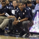FILE - In this file photo taken Nov. 1, 2012, Connecticut head coach Kevin Ollie, right, watches play during the first half of an NCAA college basketball game in Storrs, Conn. UConn called a news conference for Saturday, Dec. 29, 2012, to announce a new contract for Ollie. A person in the athletic department said the final details were still being worked out and the contract had not been signed. The person spoke on condition of anonymity because he was not authorized to speak before the news conference. (AP Photo/Jessica Hill, file)