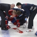Montreal Canadiens' Lars Eller receives medical attention following a hit by Ottawa Senators' Eric Gryba during the second period of Game 1 of an NHL hockey Stanley Cup playoffs first-round series in Montreal on Thursday, May 2, 2013. (AP Photo/The Canadian Press, Graham Hughes)