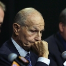 Boston Bruins owner Jeremy Jacobs, center, listens to a reporter's question during a news conference in Boston, Tuesday, May 20, 2014. The Bruins were eliminated from the NHL hockey playoffs by the Montreal Canadiens. At left is Jeremy's son Charlie Jacobs, principal of Delaware North Companies, Inc. and the Boston Bruins and at right is Cam Neely, Bruins president. (AP Photo/Charles Krupa)