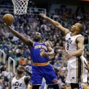 New York Knicks' Raymond Felton (2) lays the ball up as Utah Jazz's Randy Foye (8) defends and Jazz's Mo Williams (5) watches in the first quarter of an NBA basketball game Monday, March 18, 2013, in Salt Lake City. (AP Photo/Rick Bowmer)