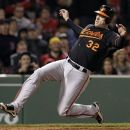 Baltimore Orioles' Matt Wieters (32) slides in to score on a single by Chris Davis against the Boston Red Sox in the 13th inning of a baseball game at Fenway Park in Boston, Friday, May 4, 2012. (AP Photo/Elise Amendola)