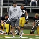 In this April 14, 2013 photo, Iowa offensive line coach Brian Ferentz walks across the field during Iowa's open college football practice at Valley High School Stadium in West Des Moines, Iowa. His first season back was hardly what the younger Ferentz was hoping for after jumping from New England to Iowa City.(AP Photo/Charlie Neibergall)