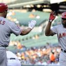 Los Angeles Angels' Torii Hunter (48) celebrates his home run with teammate Albert Pujols (5) during the first inning of a baseball game against the Baltimore Orioles, Wednesday, June 27, 2012, in Baltimore. (AP Photo/Nick Wass)