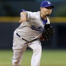 Los Angeles Dodgers starting pitcher Josh Beckett delivers during the first inning of a baseball game against the Colorado Rockies in Denver, Monday, Aug. 27, 2012. (AP Photo/Joe Mahoney)
